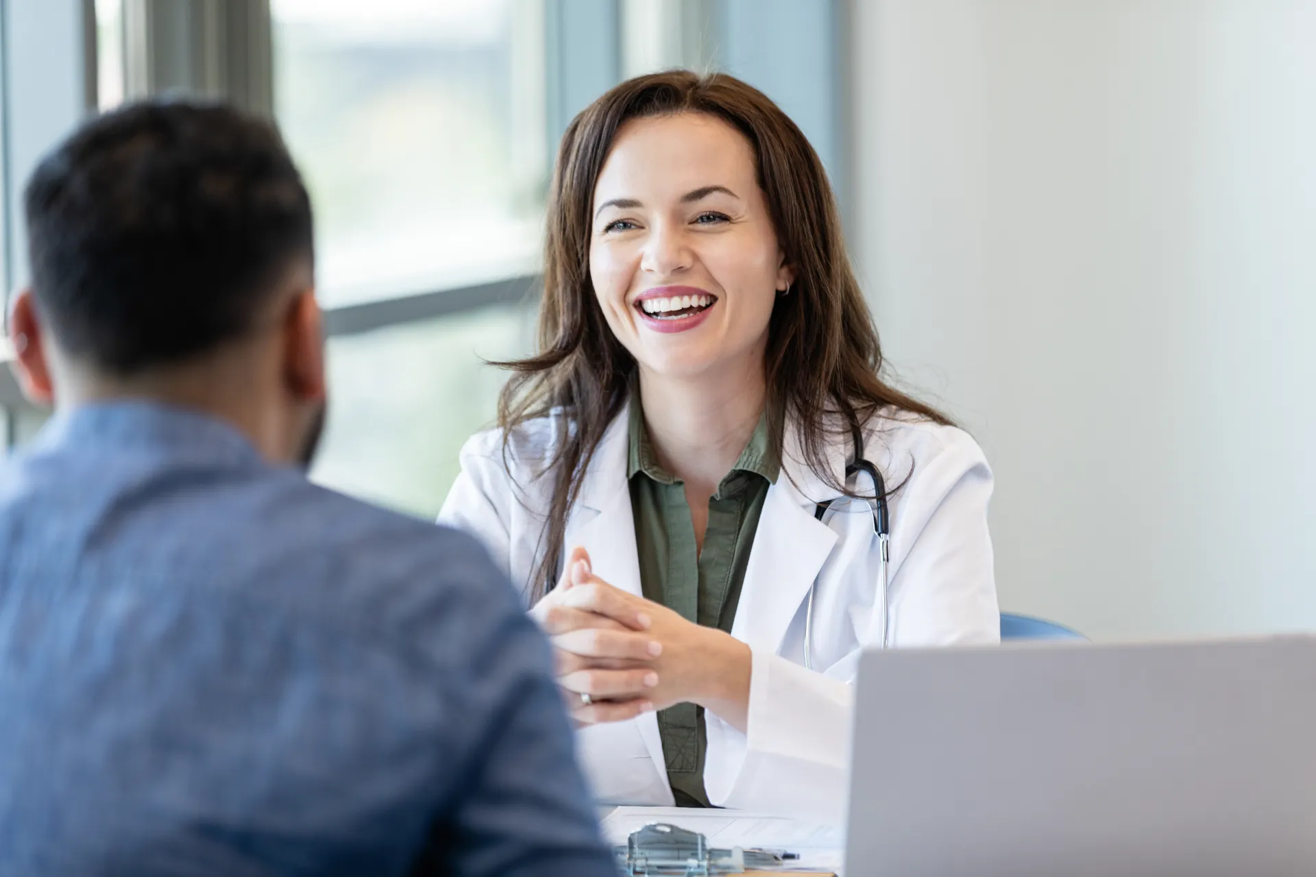 A practice owner laughing with her advisor during a planning session